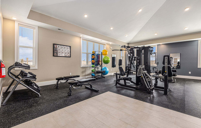 a gym with exercise equipment and weights  at Signature Pointe Apartment Homes, Athens, AL, 35611