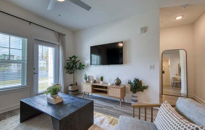 A living room with a black coffee table and a grey sofa.