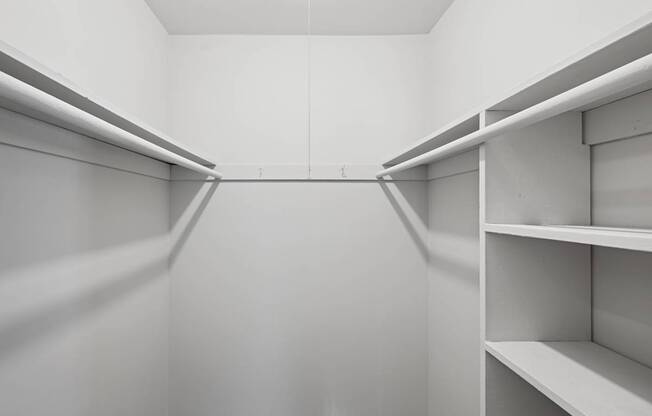 Empty white shelves in a room.