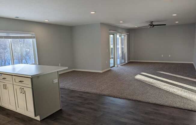 a kitchen and living room with a door to a patio