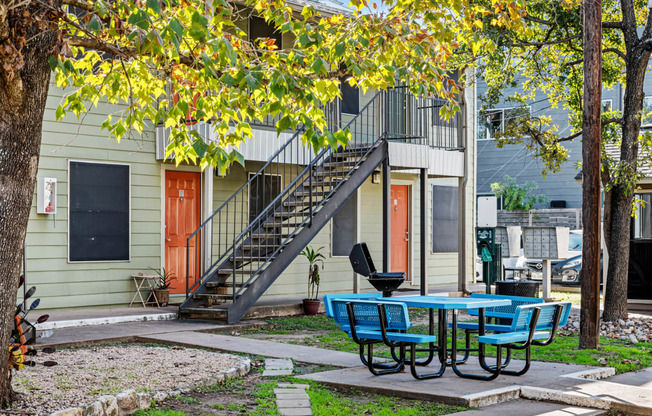 our apartments have a patio with a table and chairs