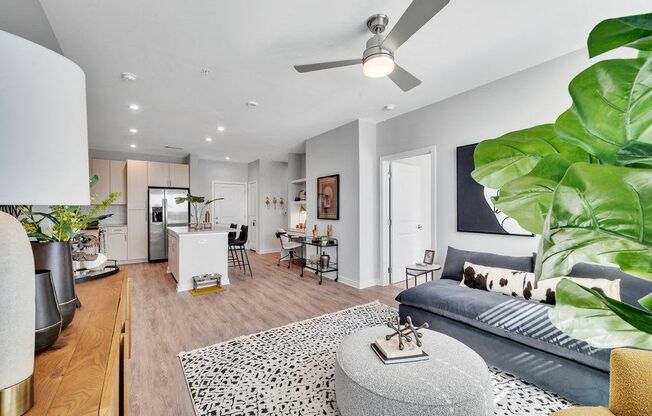 a living room with a couch and a ceiling fan