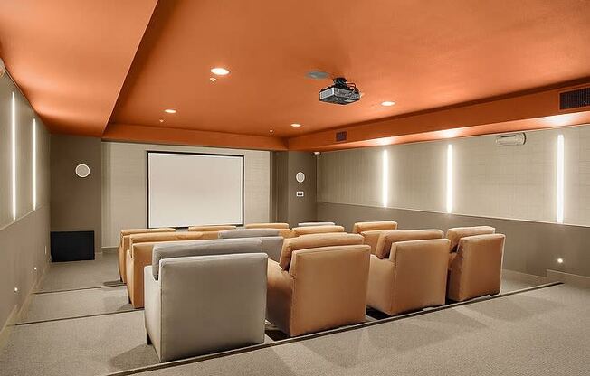 a room with a projector screen and chairs