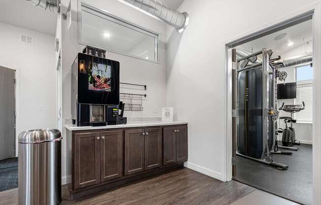 A room with a TV, a trash can, and a gym setup.