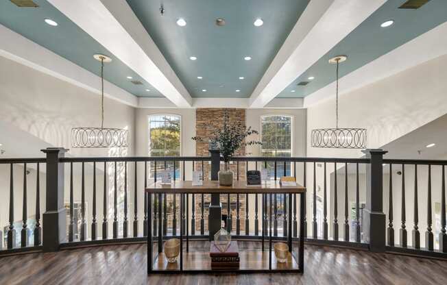 Indoor area with vaulted ceilings and balcony railing