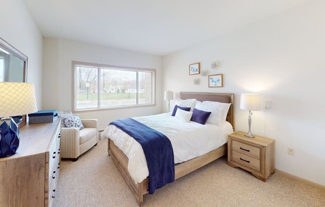 A bedroom with a large bed and a window.
