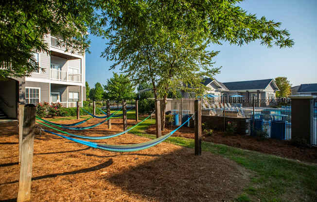 a playground with hammocks in front of an apartment building at The Shallowford, Chattanooga, TN, 37421