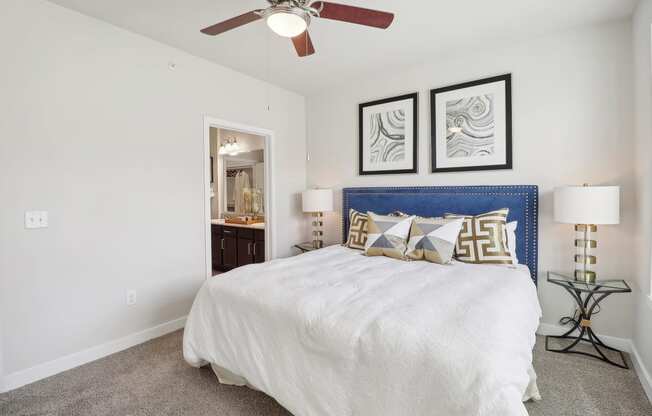 a bedroom with a large bed and a ceiling fan