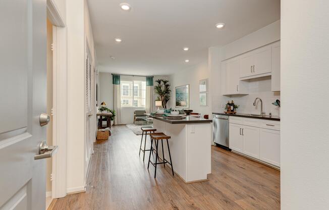 a kitchen with a sink and a mirror in a room