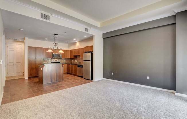 A kitchen with a refrigerator, microwave, and oven.