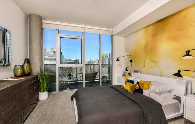 master bedroom with large windows at K1 Apartments, San Diego, CA