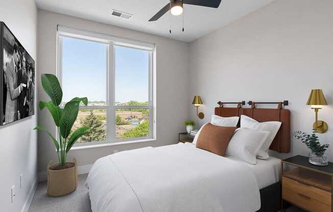 a bedroom with a large bed and a window