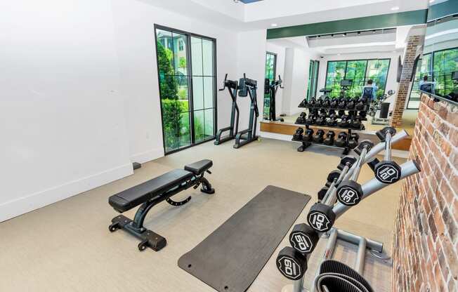 a workout room with weights and other exercise equipment