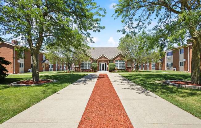 a sidewalk in front of a building with trees