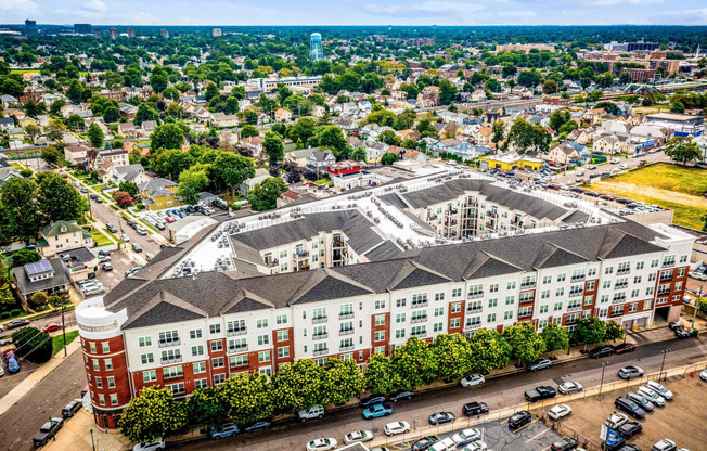 an aerial view of a large building in a city at Metro 303, Hempstead, NY