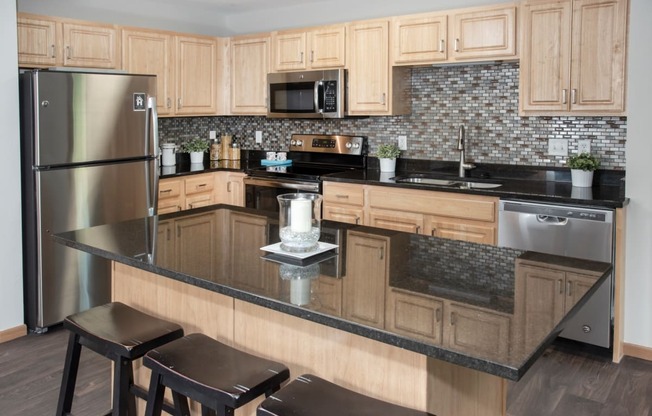 kitchen with island, granite countertop, tile backsplash