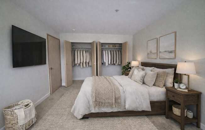 A bedroom with a large bed and a TV on the wall.