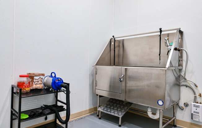 a large stainless steel sink in the corner of a room