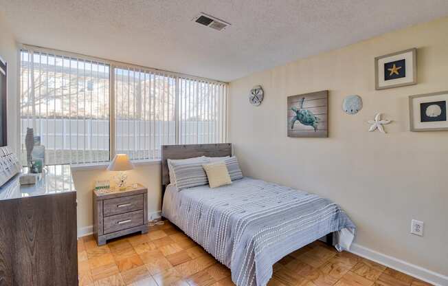 a bedroom with a bed and a large window