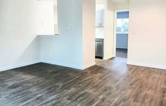 A room with a wooden floor and white walls.