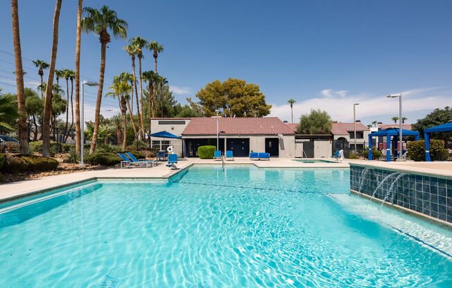 a large swimming pool with a building in the background