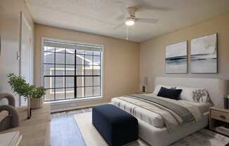 A bedroom with a large bed and a window with a view of a building.