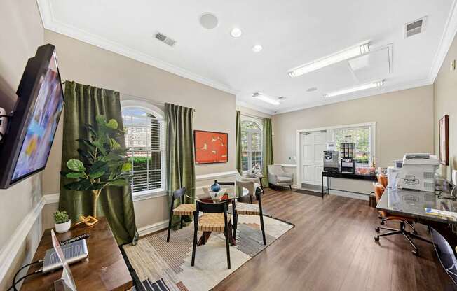 A living room with a television on the left and a dining area in the middle.