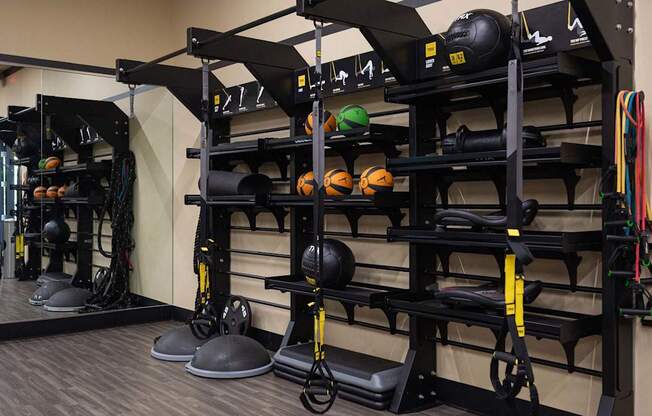 A gym with a variety of equipment including weights and resistance bands.