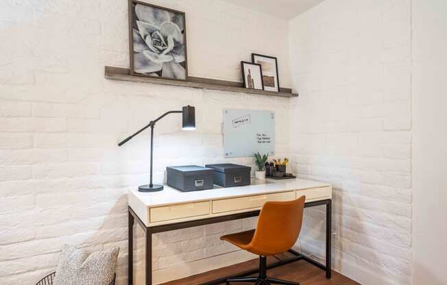 a desk with a lamp and two boxes on it