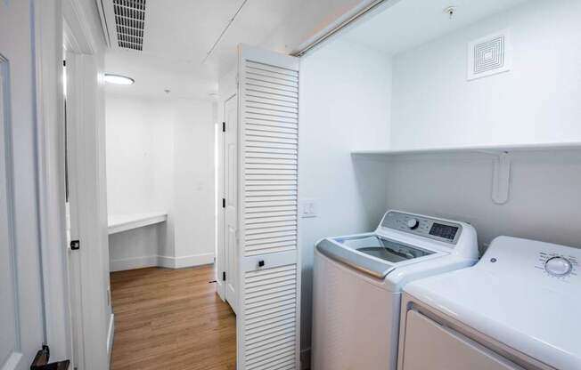 A small laundry room with a washer and dryer.