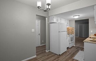 a kitchen with a white refrigerator and a stove