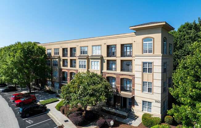 A large building with a parking lot in front of it.