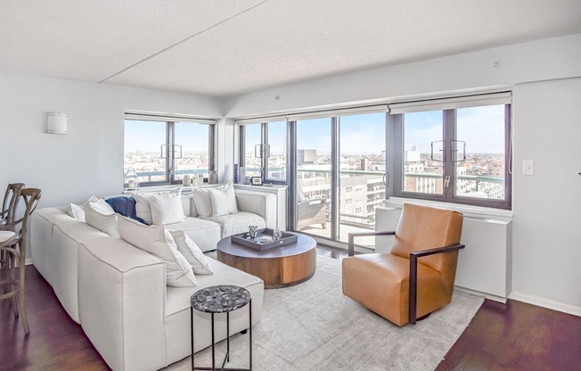 a living room with white couches and a coffee table