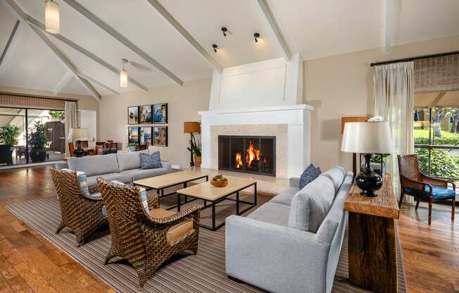 a living room with couches and chairs and a fireplace