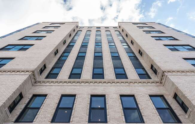 Fully renovated exterior of the Century apartment building preserving its historic charm