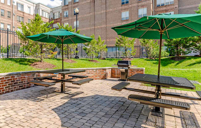 Apartments for Rent in Camp Springs, MD - Tribeca at Camp Springs - A patio with a table and chairs and umbrellas