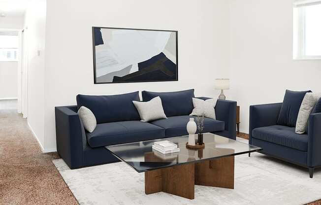 A living room with a blue couch and a coffee table.