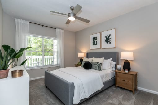 spacious bedroom with ceiling fan and window at the preserve at greatstone