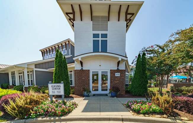 the entrance to the garden center building with a sign in front