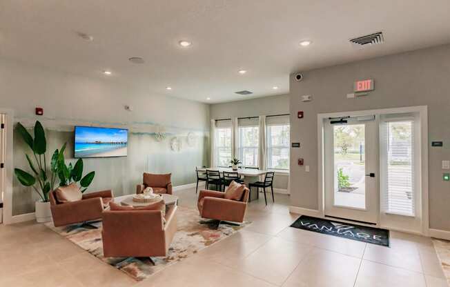 lounge area with chairs and a tv at Vantage Luxury Apartments in Cape Coral, FL
