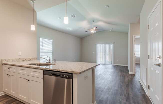 an empty kitchen with a counter top and a stainless steel dishwasher