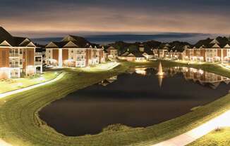 view of lake at Falcon Creek Luxury Apartments at night