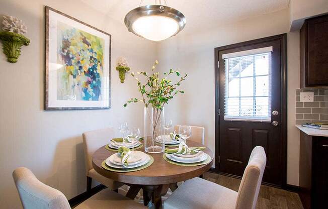 Gorgeous Dining Room Space with Elegant Lighting and Wood Plank Vinyl Flooring at Artesian East Village, Atlanta, GA 30316