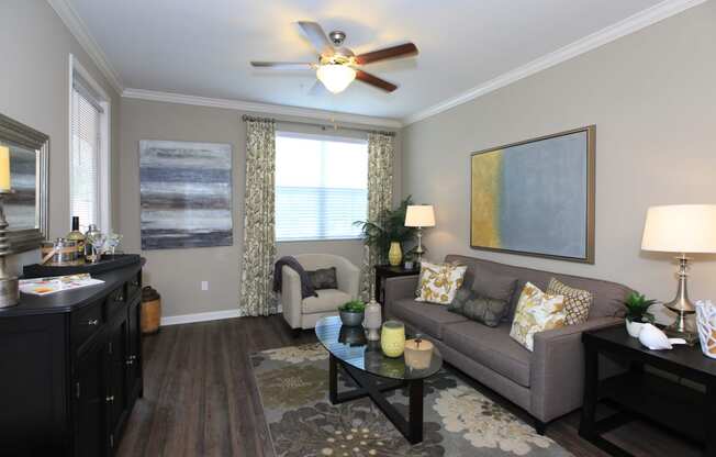 a living room with a ceiling fan and a couch