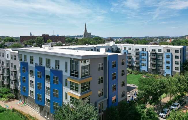 an aerial view of an apartment complex with a church in the background