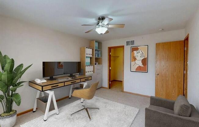 Guest room converted into a work from home office. Space is filled with natural light  and plenty of space for storage or decor.