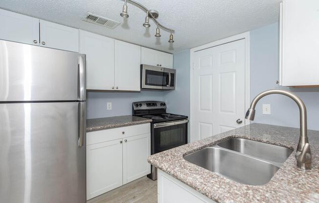 a kitchen with a sink and a refrigerator