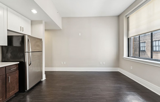 a kitchen with a refrigerator freezer next to a window