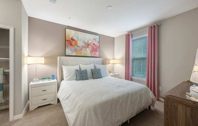 a bedroom with a large bed and a window