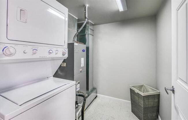 A white oven and dryer in a small laundry room.